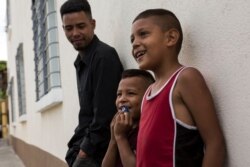 Migrants from Honduras wait outside the Migrant's House shelter in Guatemala City, July 26, 2019.