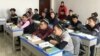 Para mahasiswa Muslim Uighur mengikuti kelas di Institut Islam Xinjiang, dalam sebuah acara yang diatur oleh pemerintah China, di kota Urumqi, Xinjiang, 3 Januari 2019.