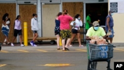 Terry Shelvin stocks up on water and food as Hurricane Ida approaches Louisiana, Aug. 29, 2021, in Lafayette, La.