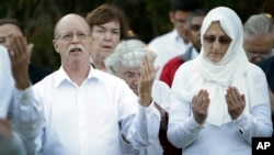 Ed and Paula Kassig, in foreground, pray at a vigil for son Abdul-Rahman Kassig at Butler University in Indianapolis, Indiana, on Oct. 8, 2014.