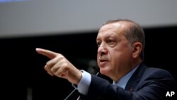 Turkey's President Recep Tayyip Erdogan, gestures as he delivers a speech during a ceremony to rejoin the ruling Justice and Development Party, or AKP, in Ankara, Turkey, May 2, 2017. 