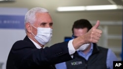 Vice President Mike Pence gestures while visiting the General Motors/Ventec ventilator production facility in Kokomo, Ind., April 30, 2020.