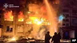 Firefighters put out the fire following a Russian rocket attack in Dobropillya, Donetsk region, Ukraine, March 8, 2025. (Ukrainian Emergency Service via AP)