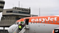 FILE - Passengers board an easyJet plane at Tegel Airport in Berlin, Germany, Jan. 5, 2018 for the British airline's first domestic flight within Germany.