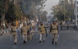 FILE - Assam police women patrol during a curfew in Gauhati, India, Dec. 12, 2019.