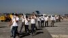 FILE - Guatemalan migrants walk on the tarmac after being deported from the U.S., at La Aurora International Airport in Guatemala City, Nov. 21, 2019.