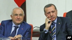 Turkey's Prime Minister Recep Tayyip Erdogan (R) and then-deputy Cemil Cicek listen as Interior Minister Besir Atalay [not pictured] addresses members of parliament during a debate at the Turkish Parliament in Ankara, Turkey, November 2009. (file photo)