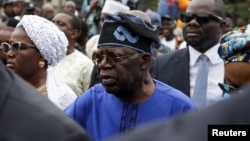 Presidential candidate Bola Ahmed Tinubu arrives at a polling station before casting his ballot in Ikeja, Lagos, Nigeria Feb. 25, 2023.