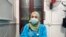 This May 13, 2020, picture provided by Dr. Marwa al-Khafaji shows the doctor back at work after 20 days in isolation after she tested positive for the coronavirus at a hospital in Karbala, Iraq. 