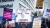 NHS nurses display signs at a strike, due to a dispute with the government over pay, outside St Thomas' Hospital in London, Britain Dec. 15, 2022. 