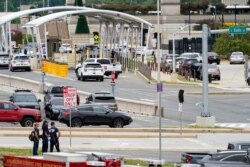 Emergency vehicles are seen outside the Pentagon Metro area Tuesday, Aug. 3, 2021, at the Pentagon in Washington. The Pentagon is on lockdown after multiple gunshots were fired near a platform by the facility's Metro station. (AP Photo/Andrew Harnik)