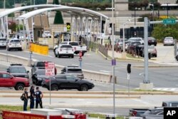 Emergency vehicles are seen outside the Pentagon Metro area Tuesday, Aug. 3, 2021, at the Pentagon in Washington. The Pentagon is on lockdown after multiple gunshots were fired near a platform by the facility's Metro station. (AP Photo/Andrew Harnik)