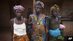 Women who survived the civil war pose for a portrait in the village of Bomaru, where the conflict started in 1991, in eastern Sierra Leone, April 22, 2012.