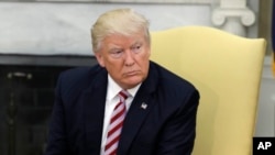 President Donald Trump talks to reporters in the Oval Office of the White House in Washington, May 10, 2017.