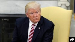 President Donald Trump talks to reporters in the Oval Office of the White House in Washington, May 10, 2017.