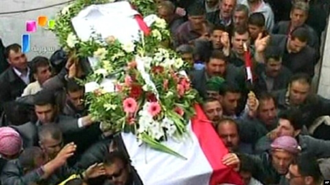 Syrian state television video footage shows mourners carrying a coffin during the funeral of two members of the security forces after they were allegedly killed by "armed groups", in Hama, north of Damascus, on April 10, 2011