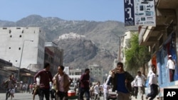 Anti-government protesters run after soldiers opened fire to disperse them as they began gathering for a demonstration to demand the ouster of Yemen's President Ali Abdullah Saleh in the southern city of Taiz, May 31, 2011