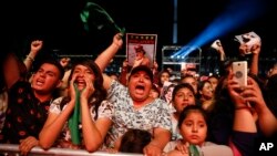 Spectators chant "Justice" in Spanish during a concert by female performers on the eve of International Women's Day, in the Zocalo in Mexico City, March 7, 2020.