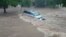 A vehicle sits in flowing floodwater in Culiacan, Sinaloa State, Mexico, Sept. 20, 2018, in this image obtained from social media video. 