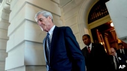 FILE - Special counsel Robert Mueller, who is looking into Russian interference in the 2016 U.S. presidential election, departs Capitol Hill following a closed-door meeting in Washington, June 21, 2017.