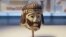 This June 4, 2018 photo shows a detailed figurine of a king's head, dating to biblical times, on display at the Israel Museum and found last year near Israel's northern border with Lebanon, in Jerusalem.