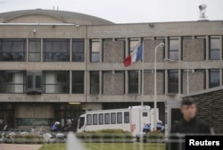 French gendarme and police stand at the entrance of the Fleury-Merogis prison near Paris after the arrival of a police convoy believed to be carrying Salah Abdeslam in Paris, May 20, 2016.