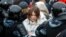 Russia, Moscow, Law enforcement officers detain a woman during a rally in support of jailed Russian opposition leader Alexei Navalny