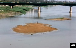 FILE - Significantly lower water levels are seen on the Tigris River, in Baghdad, Iraq, June 5, 2018.