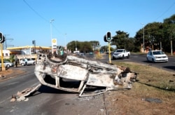 A burnt-out vehicle at an intersection in Phoenix, near Durban, South Africa, July 16, 2021, after violence in the town.