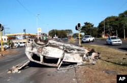 A burnt-out vehicle at an intersection in Phoenix, near Durban, South Africa, July 16, 2021, after violence in the town.