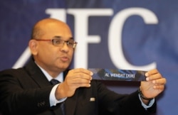 FILE - Asian Football Confederation (AFC) Executive Director Windsor John displays a slip during the draw for the AFC Cup Knockout Stage at the AFC House in Kuala Lumpur, June 14, 2012.