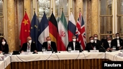 FILE - Enrique Mora, of the European External Action Service, and Ali Bagheri Kani, Iran's chief nuclear negotiator, wait for the start of talks on the Iran nuclear deal in Vienna, Austria, Dec. 3, 2021.