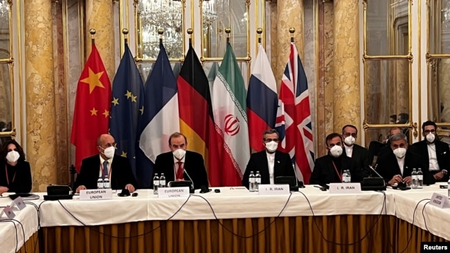 FILE - Enrique Mora, of the European External Action Service, and Ali Bagheri Kani, Iran's chief nuclear negotiator, wait for the start of talks on the Iran nuclear deal in Vienna, Austria, Dec. 3, 2021.