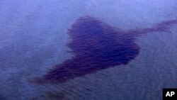 FILE - A section of an oil spill is seen off the coast of the Niger Delta in Nigeria, Dec. 26, 2011.