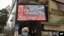 A TV screen broadcasts the news of the opening session of China's National People's Congress (NPC), in Hong Kong, March 5, 2021.