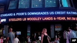 An ABC News ticker reads "Standard & Poor's downgrades US credit rating from AAA to AA+" in Times Square on August 5, 2011 in New York City.