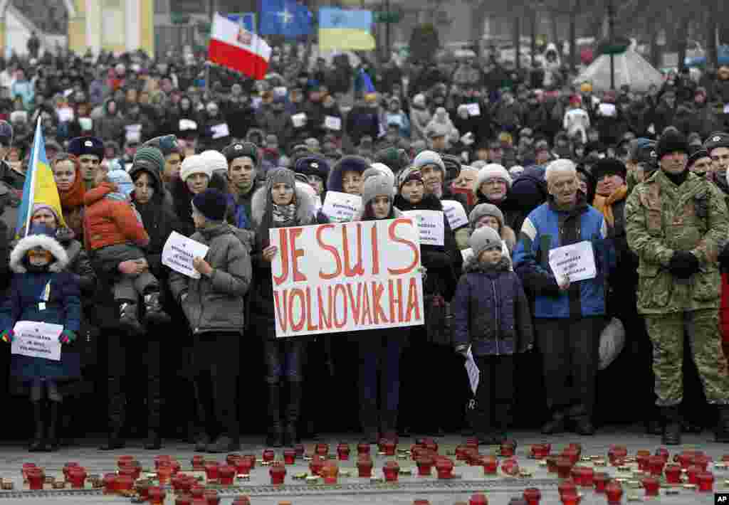 People hold up signs reading &quot;I Am Volnovakha&quot; during a rally at Independence Square in Kyiv in solidarity with the victims of a rocket attack this week that claimed 13 lives on a highway near the eastern town of Volnovakha, Ukraine, Jan. 18, 2015.