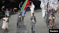 Eritrea's flag bearer Weynay Ghebresilasie holds the national flag as he leads the contingent in the athletes parade during the opening ceremony of the London 2012 Olympic Games, July 27, 2012. 