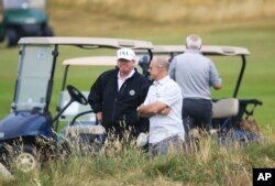 U.S. President Donald Trump waits on the fourth tee at Turnberry golf course, Scotland, July 14, 2018.