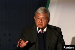 FILE - Mexican President-elect Andres Manuel Lopez Obrador talks about his security plan to the media in Mexico City, Nov. 14, 2018.