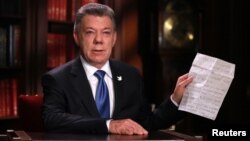 FILE - Colombia's President Juan Manuel Santos speaks during a presidential address in Bogota, Oct. 10, 2016.