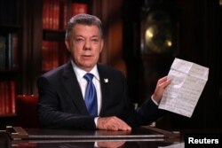 FILE - Colombia's President Juan Manuel Santos speaks during a presidential address in Bogota, Oct. 10, 2016.