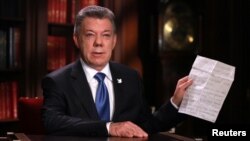 FILE - Colombia's President Juan Manuel Santos speaks during a presidential address in Bogota, Oct. 10, 2016.