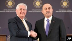 Turkey's Foreign Minister Mevlut Cavusoglu, right, shakes hands with U.S. Secretary of State Rex Tillerson, left, after a joint news conference following their meeting in Ankara, Turkey, Feb. 16, 2018.