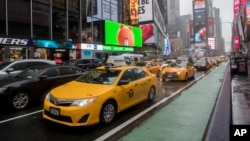 FILE - Traffic makes its way down Seventh Avenue in New York's Times Square, May 25, 2017. Cruise Automation, a self-driving software company owned by General Motors, said it would start testing in New York in early 2018.