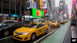 FILE - Traffic makes its way down Seventh Avenue in New York's Times Square, May 25, 2017. 