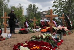 People attend the funeral of Russian sailors, who were killed in a fire on a secret nuclear submersible in the Barents Sea, at Serafimovskoye cemetery in Saint Petersburg, Russia, July 6, 2019.