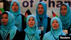 FILE - Girls sing the Afghan national anthem at an event in Kabul, Afghanistan, Sept. 26, 2013.