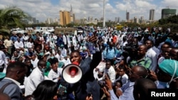 Ouma Oluga, Secretary-General of the Kenya Medical Practitioners, Pharmacists and Dentist Union (KMPDU), addresses doctors during a strike to demand fulfillment of a 2013 agreement between their union and the government, outside Ministry of Health headquarters in Nairobi, Dec. 5, 2016.