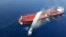 An Iranian navy boat sprays water to extinguish a fire on an oil tanker in the sea of Oman, Thursday, June 13, 2019.